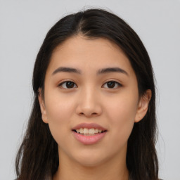 Joyful asian young-adult female with long  brown hair and brown eyes