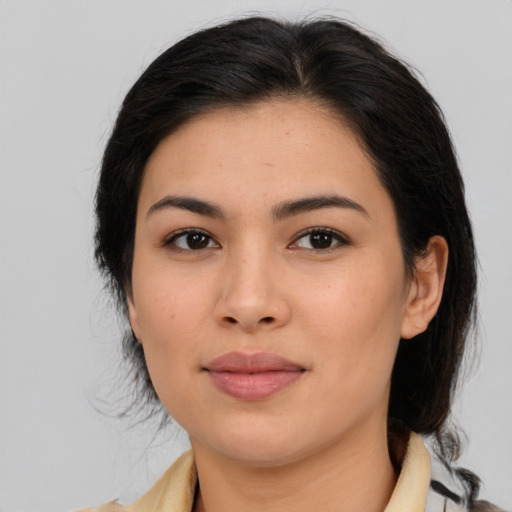 Joyful latino young-adult female with medium  brown hair and brown eyes