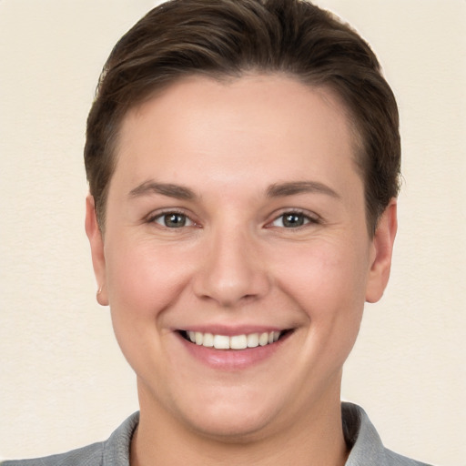 Joyful white young-adult female with short  brown hair and brown eyes