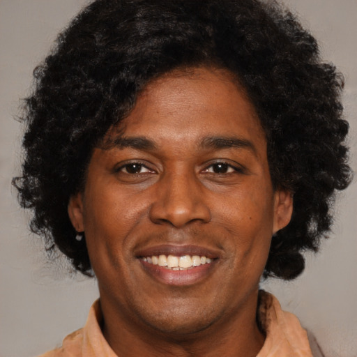 Joyful latino adult male with short  black hair and brown eyes