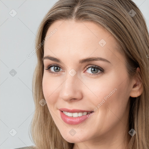 Joyful white young-adult female with long  brown hair and brown eyes