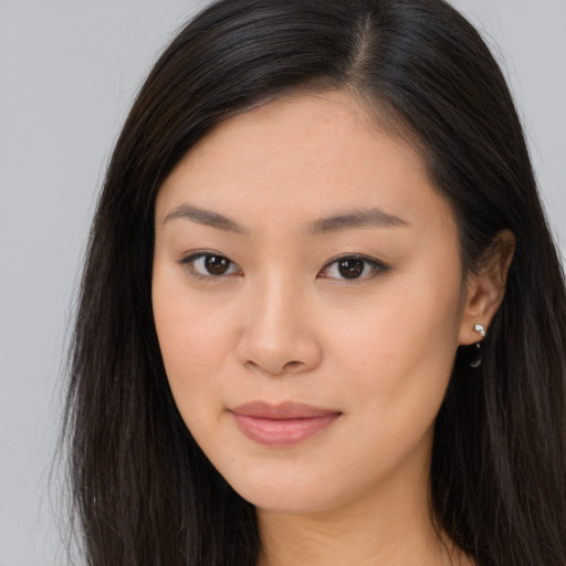 Joyful asian young-adult female with long  brown hair and brown eyes