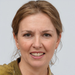 Joyful white adult female with medium  brown hair and grey eyes