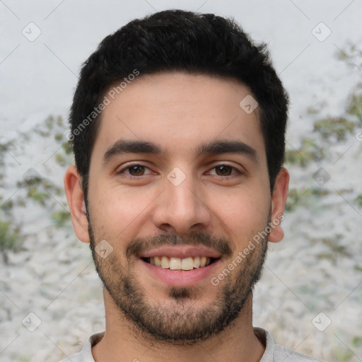 Joyful white young-adult male with short  black hair and brown eyes