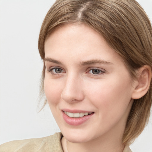 Joyful white young-adult female with medium  brown hair and blue eyes