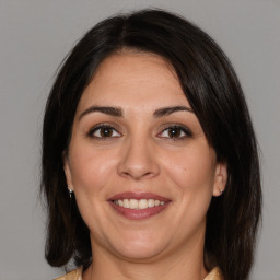 Joyful white adult female with medium  brown hair and brown eyes