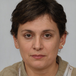 Joyful white adult female with short  brown hair and brown eyes