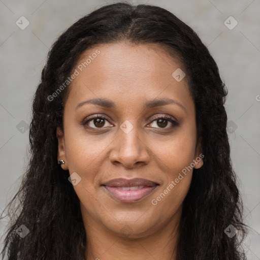 Joyful black young-adult female with long  brown hair and brown eyes