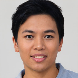 Joyful asian young-adult male with short  black hair and brown eyes