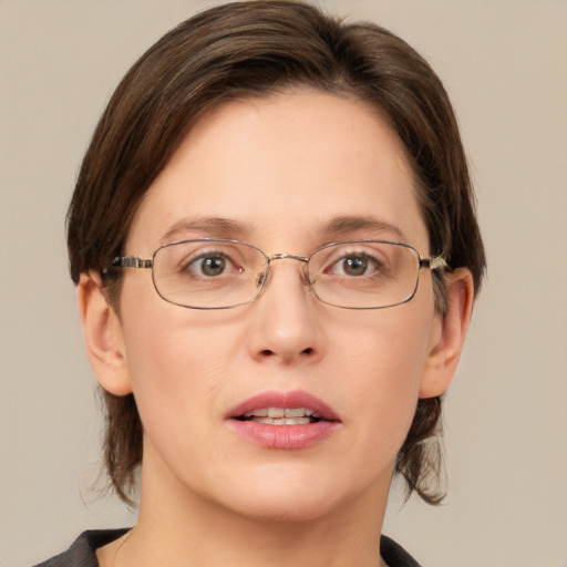 Joyful white young-adult female with medium  brown hair and green eyes