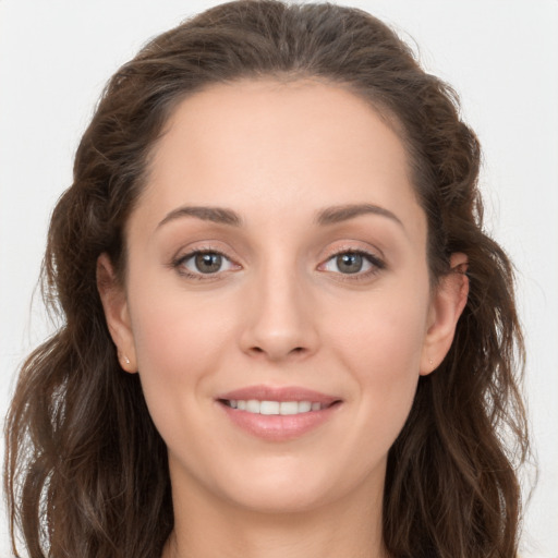 Joyful white young-adult female with long  brown hair and grey eyes