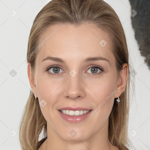 Joyful white young-adult female with long  brown hair and grey eyes