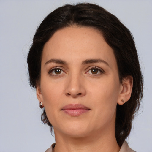 Joyful white adult female with medium  brown hair and brown eyes