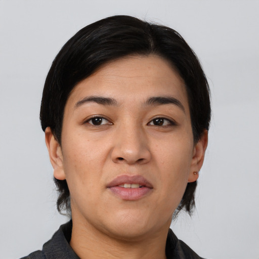 Joyful asian young-adult female with medium  black hair and brown eyes