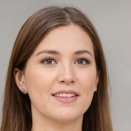 Joyful white young-adult female with long  brown hair and brown eyes