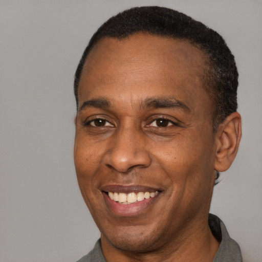 Joyful latino adult male with short  black hair and brown eyes