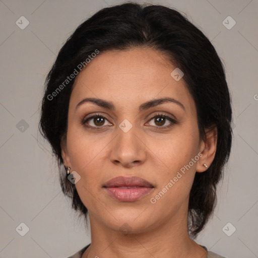 Joyful latino adult female with medium  brown hair and brown eyes