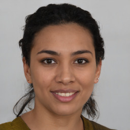 Joyful latino young-adult female with short  brown hair and brown eyes