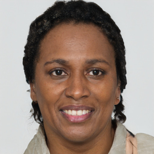 Joyful black adult female with short  black hair and brown eyes