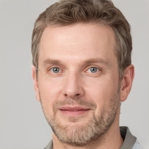 Joyful white adult male with short  brown hair and grey eyes