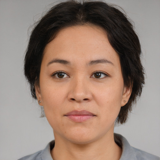 Joyful asian adult female with medium  brown hair and brown eyes