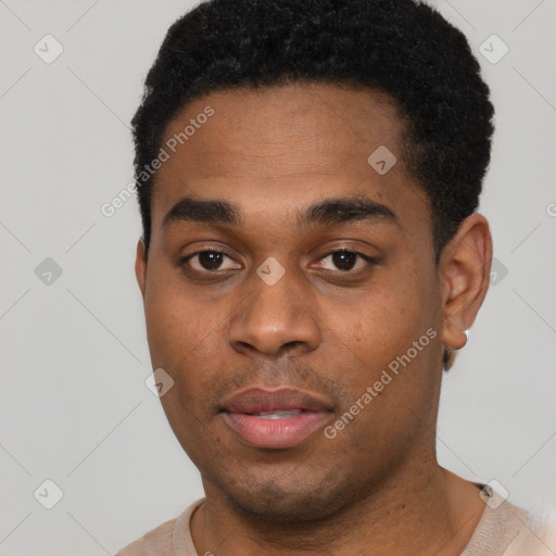 Joyful black young-adult male with short  black hair and brown eyes