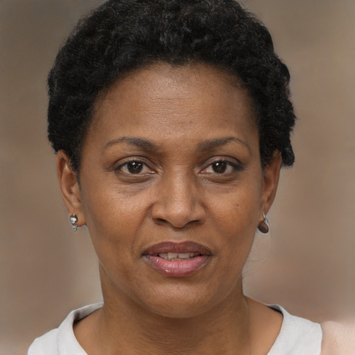 Joyful black adult female with short  brown hair and brown eyes
