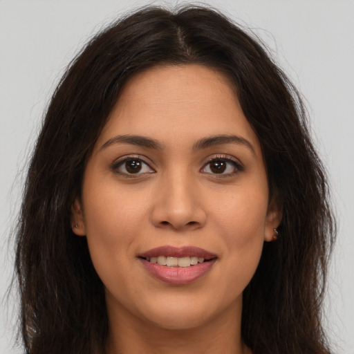 Joyful white young-adult female with long  brown hair and brown eyes
