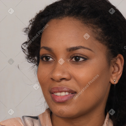 Joyful black young-adult female with long  brown hair and brown eyes