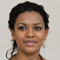 Joyful black young-adult female with short  brown hair and brown eyes