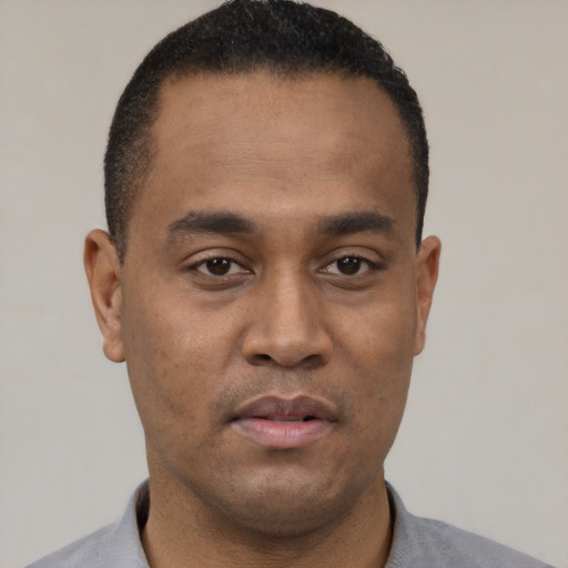 Neutral black young-adult male with short  black hair and brown eyes