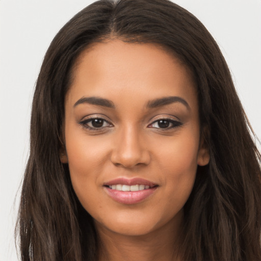 Joyful latino young-adult female with long  brown hair and brown eyes