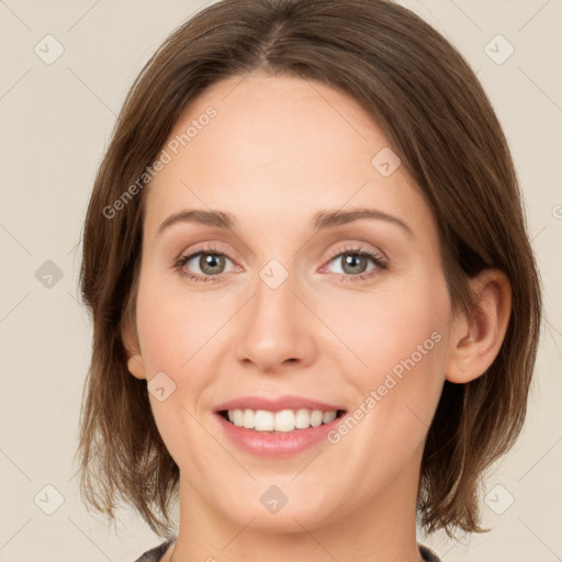 Joyful white young-adult female with medium  brown hair and green eyes