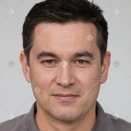 Joyful white adult male with short  brown hair and brown eyes