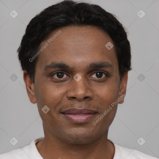 Joyful black young-adult male with short  black hair and brown eyes