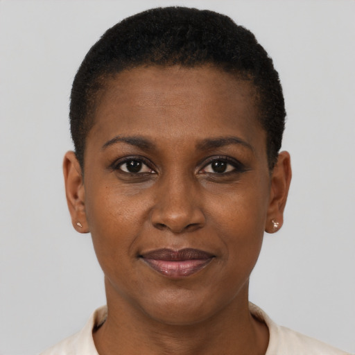 Joyful black young-adult female with short  black hair and brown eyes