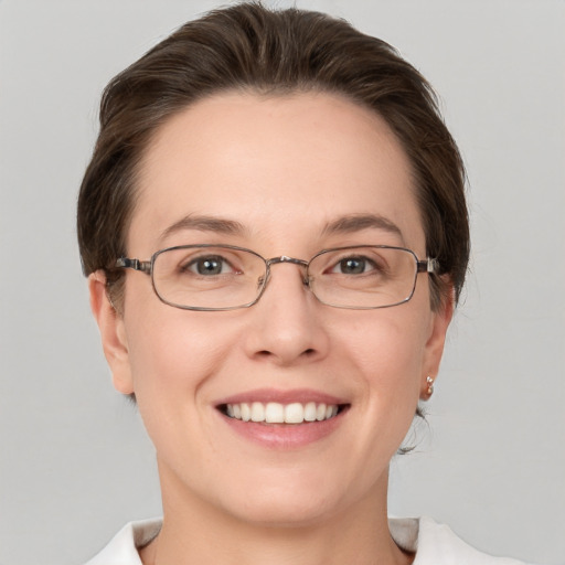 Joyful white young-adult female with short  brown hair and grey eyes