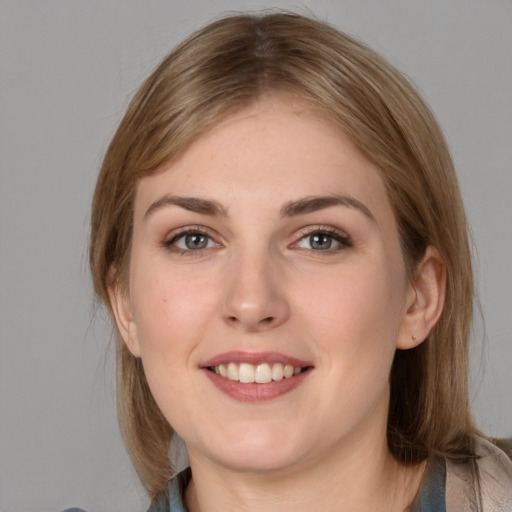 Joyful white young-adult female with medium  brown hair and grey eyes