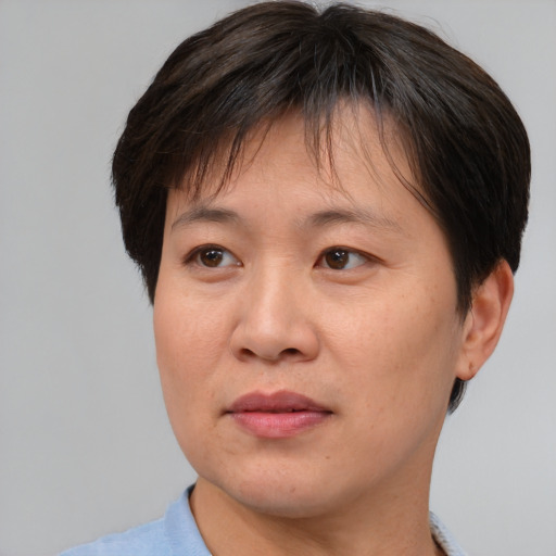 Joyful asian adult female with short  brown hair and brown eyes