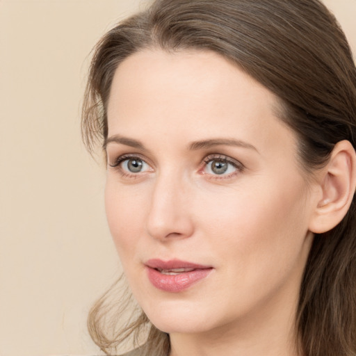 Joyful white young-adult female with long  brown hair and grey eyes