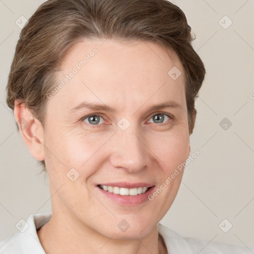 Joyful white adult female with short  brown hair and grey eyes