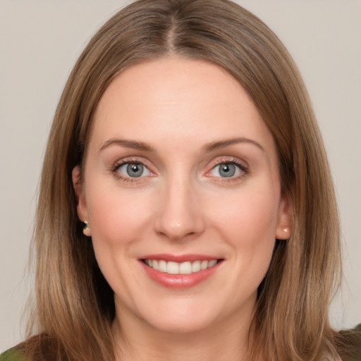 Joyful white young-adult female with medium  brown hair and green eyes