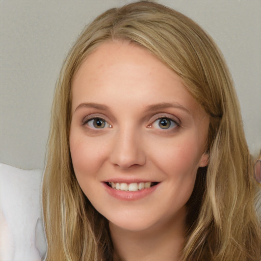 Joyful white young-adult female with long  brown hair and blue eyes