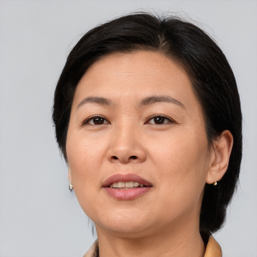 Joyful asian adult female with medium  brown hair and brown eyes