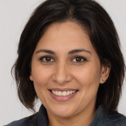 Joyful white adult female with medium  brown hair and brown eyes