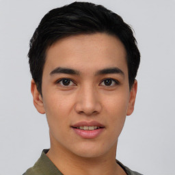 Joyful asian young-adult male with short  black hair and brown eyes