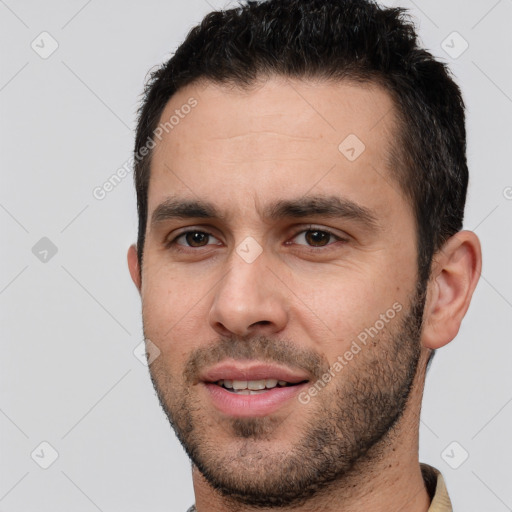 Joyful white young-adult male with short  brown hair and brown eyes