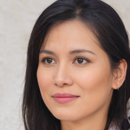 Joyful asian young-adult female with long  brown hair and brown eyes