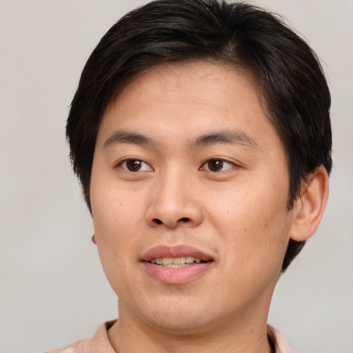 Joyful asian young-adult male with short  brown hair and brown eyes