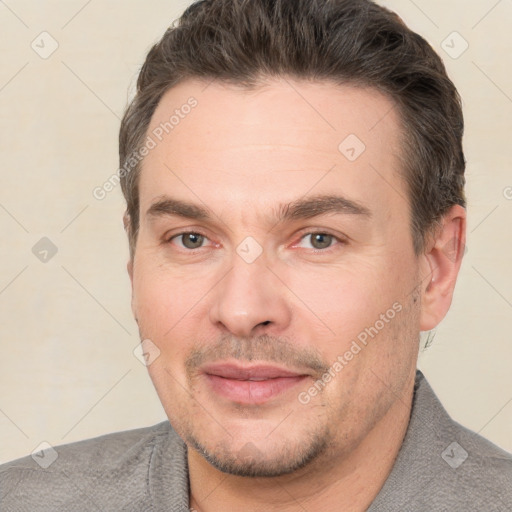 Joyful white adult male with short  brown hair and brown eyes